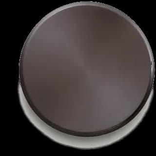 Blackened Brass finish sample — hand-applied metal disc