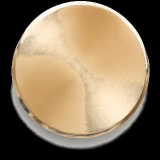 Satin Brass finish sample — hand-applied metal disc